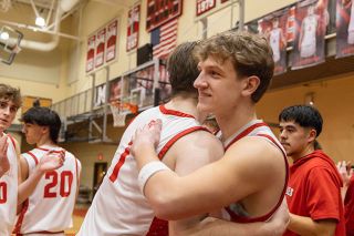 Nathan Ecker/News-Register##Dylan Ferrua finds fellow senior Kaeden Chapman for an embrace prior to their final game. Despite early struggles, the Grizzly seniors were proud of their effort in the season&rsquo;s final stretch.