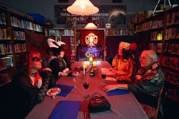 Rachel Thompson/News-Register##Costumed players gather around a candlelit table to compare clues during the Willamina Public Library&rsquo;s &ldquo;Immortal Murders&rdquo; interactive murder mystery fundraiser Feb. 28. From left are Bridget Kiger of Sheridan as Natasha, Quinn Keller of Portland as Henrik, Katy Morrow of Sheridan as Bounty and Ann Gage of Ballston as Jessica.