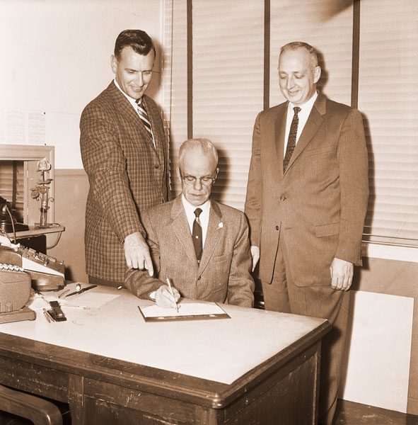 ##(March 3, 1961) Pointing out a bright spot in the just-started Yamhill County Chapter Red Cross fund drive is Glen Macy, chapter chairman, as Rev. S. James Osborne (seated) goes over some figures. Another Red Cross official eager to see the drive reach its goal of $13,546 soon is Jack Coleman (right), chapter executive secretary.