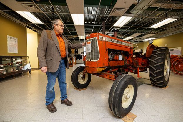 Rachel Thompson/News-Register##Wade Miller, who grew up using Allis-Chalmers tractors and helping sell them in his family&rsquo;s farm equipment business, shows a D-19 model from the early 1960s on display in the Yamhill County History Museum.