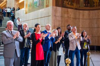 Mia Maldonado/Oregon Capital Chronicle##Oregon House Republican Leader Lucetta Elmer (in red), R-McMinnville, and other House members greet their colleagues from the Senate in a celebration of the end of the legislative session at the Capitol in Salem on Friday, March 6.