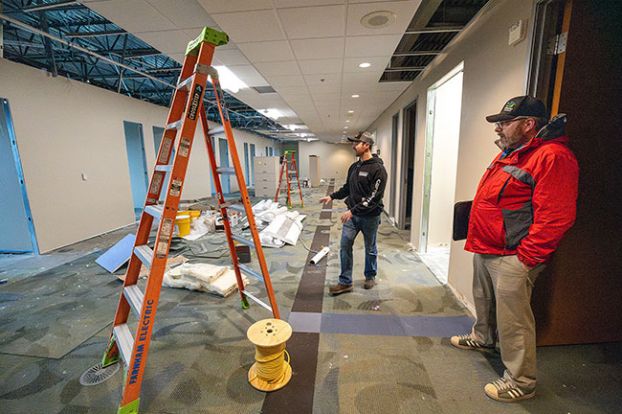 Rachel Thompson/News-Register##Project Manager Taylor Haworth, accompanied by Deputy County Administrator Kevin Perkins, right, describes how the Yamhill County Board of Commissioners offices will look when completed. The doorways lead to future offices for commissioners and county administrative staff, and ladders will be replaced by cubicles for support staff.