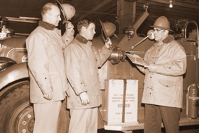 ##(March 9, 1956) Hats off to the McMinnville Fire Department are paid by Roseburg Fire Chief William Mills, left, and fireman George C. Kirby. The firemen presented a certificate of merit to the department here for a fire-fighting demonstration in Roseburg last June. McMinnville Chief Ivan Pearson holds the award, one of five given by the Roseburg department during the last 60 years. About 20 firemen staged the demonstration June 15 for firefighting methods with improvised equipment. ##(March 9, 1956) Hats off to the McMinnville Fire Department are paid by Roseburg Fire Chief William Mills, left, and fireman George C. Kirby. The firemen presented a certificate of merit to the department here for a fire-fighting demonstration in Roseburg last June. McMinnville Chief Ivan Pearson holds the award, one of five given by the Roseburg department during the last 60 years. About 20 firemen staged the demonstration June 15 for firefighting methods with improvised equipment.