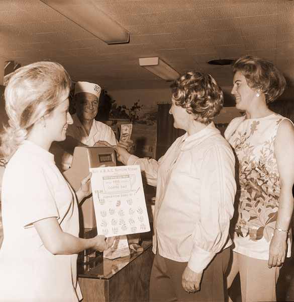 ##(March 13, 1971) Members of Gamma Lambda Chapter of ESA, service sorority, are helping sponsor the Easter Seal Society’s “Buck-a-Cup-To-Brace-a-Child“ campaign. “Buck a cup” buttons are being sold for a dollar by participating restaurants, which entitle the wearer to have free coffee March 19. One of the restaurant owners, Mike Morris of Marty’s Cafe, is shown with (I-r) Mrs. Harry Cure, Mrs. Dan Cole and Mrs. Don Cummins, sorority members. ##(March 13, 1971) Members of Gamma Lambda Chapter of ESA, service sorority, are helping sponsor the Easter Seal Society’s “Buck-a-Cup-To-Brace-a-Child“ campaign. “Buck a cup” buttons are being sold for a dollar by participating restaurants, which entitle the wearer to have free coffee March 19. One of the restaurant owners, Mike Morris of Marty’s Cafe, is shown with (I-r) Mrs. Harry Cure, Mrs. Dan Cole and Mrs. Don Cummins, sorority members.