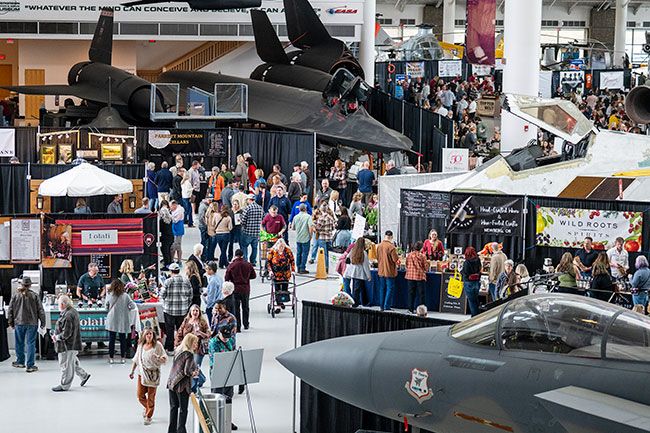 Rachel Thompson/News-Register##Visitors sample food and beverages beneath the massive wings of the Spruce Goose on Sunday during the McMinnville Wine and Food Classic, which expanded this year to occupy two buildings at Evergreen Aviation and Space Museum. &ldquo;There&rsquo;s a lot of excitement about the two museums,&rdquo; said organizer Erika Schlotfeldt of McMinnville, noting that visitors enjoyed the chance to explore more of the exhibits. With warm weather on Saturday drawing people outside to the food trucks &mdash; which at times ran out of food before restocking &mdash; she said the entire weekend brought steady crowds. &ldquo;The museum said they&rsquo;ve never seen their parking lot this full,&rdquo; she said. &ldquo;I think people are excited to see what we can do with the two museums and how we can continue to grow the event.&rdquo;