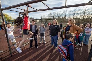 Rachel Thompson/News-Register##McMinnville Mayor Kim Morris, left, and Lafayette Mayor Hilary Malcomson, center, join Superintendent Kourtney Ferrua in supervising the monkey bars at Wascher Elementary School Wednesday morning as part of the We Care About Kids initiative. Evelyn Cortes Hernandez makes her way across as Yahilin Chacon Fabela waits her turn.