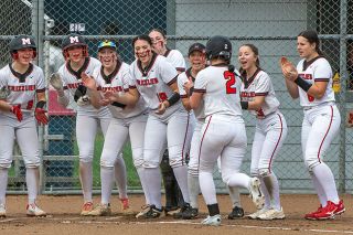 Rusty Rae/News-Register##The Grizzlies crowd around home plate to greet Dakota Mitsche following her opposite field grand slam versus Lebanon. Junior Juliet Pesina-Wade (No. 11) also homered in the contest, crediting pitch-to-pitch adjustments for her blast. Meanwhile, Mitsche made changes to her mentality and attacked the first pitch in her home run at-bat after striking in her first.