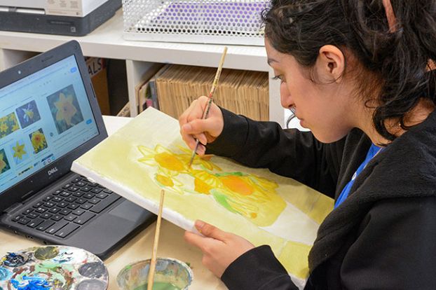 Emily Bonsant/News-Register##Amity High freshman Bridgette Arguelles works on her interpretation of &ldquo;Sunflowers&rdquo; by Vincent van Gogh in visual arts class. Students were challenged to recreate a famous piece of art while incorporating daffodils in conjunction with the Amity Daffodil Festival on March 28. Students will show and sell their art at the spring celebration.