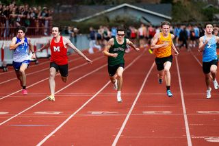 Rusty Rae/News-Register##Amity senior Trenton Ruston (left), Mac senior Kason Elkins (center) and Delphian junior Oli Beauregard (right) reach for the finish line in heat one of the boys 100-meter sprint. Elkins looks to be one of the Grizzlies top short-distance runners, placing first in the event with a time of 11.28. Beauregard, a gold medal winner in 2025, finished second (11.28) and Rustin placed sixth (11.73).