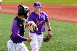 Nathan Ecker/News-Register##Linfield&rsquo;s Casey Struckmeier meets his catcher, junior Cole Snidow, for a hand to glove fist bump while excitedly walking back to their dugout following a clean inning in the team&rsquo;s 2-1 loss versus No. 1 Denison on Saturday, March 21, at Roy Helser Field. Struckmeier lowered his season ERA to 3.26 with one run over four innings in the start.