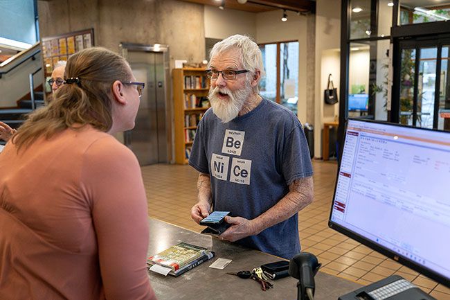 Rachel Thompson/News-Register##Mike Paull of Amity speaks with librarian Teri Swanson at the McMinnville Public Library. He is doing research for a book he&rsquo;s writing, drawing from titles including &ldquo;War at Sea in the Age of Sail&rdquo; and &ldquo;The U.S. Navy: A Concise History.&rdquo;