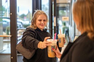 Rachel Thompson/News-Register##Elsie Best delivers a coffee to her mother, Tiffany Best, at her mom&rsquo;s workplace, First Federal &mdash; something Elsie often does. She said her mother has been a great inspiration to her, leading her to take business pathway classes at Mac High and help found the Leos, a junior Lions club, at McMinnville High School.