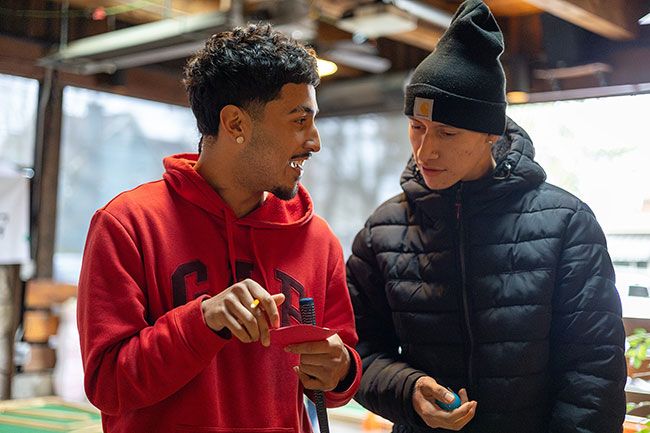 Rachel Thompson/News-Register##Bryan Casillas, left, a junior at McMinnville High School, chats over a scorecard with Adan Flores, a senior.