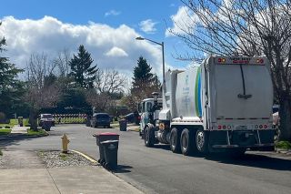Scott Unger/News-Register##A Recology truck navigates narrow Southwest Emily Drive Wednesday. The road is planned to be extended 75-feet into a cul-de-sac to provide an exit for several new plots. Neighbors say parking and traffic are already issues.