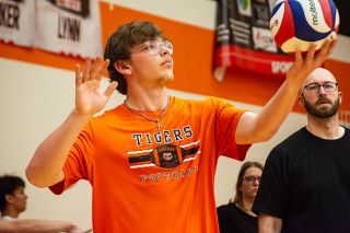 Emily Bonsant/News-Register##Yamhill Carlton senior Jason Kelley loads up a serve during a Tigers&rsquo; boys volleyball practice with coaches Tom and Jennifer Harris watching closely for any fundamental inconsistencies. With so many players new to the sport, mastering the basics are most important for the Tigers.