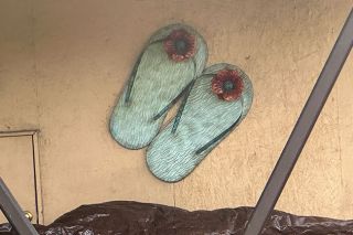 Kirby Neumann-Rea/News-Register##Carport flip-flops and suspended bicycles are joined this week by front-porch Mount Hood mosaic, unusual sun-and-moon terra cotta, and &ldquo;Frankenfoot&rdquo; on West Second near McMinnville Library.