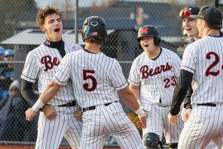 Nathan Ecker/News-Register##Mac senior Cam Hyder bumps chests with teammate Aaron Rolfe (No. 5) after scoring the winning run on a passed ball in the Grizzlies 5-4 walk-off victory over Lakeridge on Tuesday, March 31, at Patton Middle School. Rolfe tied the game at 4-4 with a double two at-bats prior.