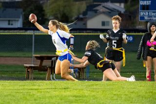 Nathan Ecker/News-Register##Amity senior Eliza Nisly pulls away from a Tualatin player while skirting the sideline on her way to a pick six in the Warriors  April 2 win. Nisly was one of several Warriors to showcase how crippling speed can be to opposing defenses.
