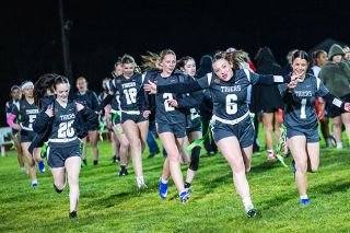Rusty Rae/News-Register##Tiger seniors Peyton Gregor (No. 6) and Kaylee Spaulding (No. 1) fly back to their sideline while celebrating their win over the Vikings. The game was one of just a few times YC has played at home and the players were ecstatic to be in front of a home crowd.
