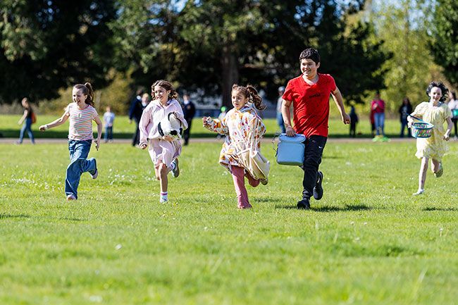 Rachel Thompson/News-Register##Children race to collect eggs during the fourth- through sixth-grade egg hunt Saturday morning behind Dayton Grade School.