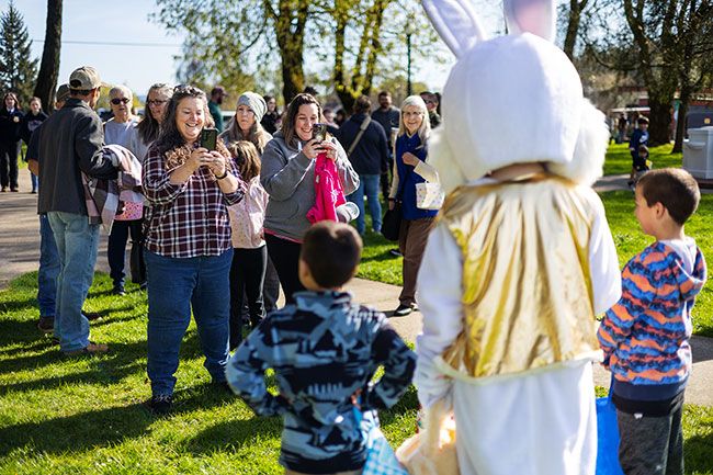 Rachel Thompson/News-Register##Kimberly Courtin, left, smiles with her daughter Kayla Gray as they photograph Courtin&rsquo;s children with the Easter Bunny during the 34th annual Dayton FFA/City Council Easter Egg Hunt Saturday in Dayton&rsquo;s Courthouse Square Park. Gray grew up attending the event as a child.