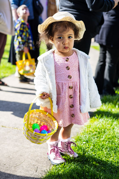 Rachel Thompson/News-Register##Kayara Maybray, 2, of Eugene, carries her basket of eggs in the park. She was visiting her grandmother for Easter weekend.