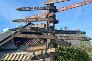 Kirby Neumann-Rea/News-Register##Tina&rsquo;s directional sign points to destinations near and far.