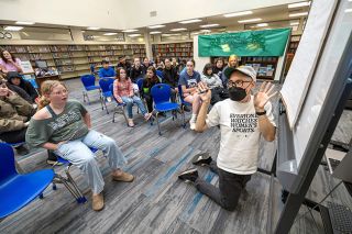 Rachel Thompson/News-Register##While drawing cryptids described by Patton Middle School students, author Jonathan Hill shows off hands that will, in the drawing, be made up of gummy bears. &ldquo;This is the weirdest thing I&rsquo;ve ever drawn,&rdquo; Hill said, to the delight of the sixth- through eighth-graders.