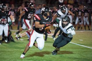 News-Register file photo##McMinnville&rsquo;s Spencer Payne rushes, likely for a hefty amount of yards, past a linebacker in a Grizzlies home contest versus Tigard on Sept. 9, 2012 at Wortman Stadium. Payne enters the MHS Hall of Fame on May 2, recognized for his accomplishments as a Grizzly.