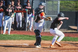 Rusty Rae/News-Register##Masin Hinkley sneaks by the glove of Bulldogs&rsquo; catcher Carter Felton to score a run. Hinkley thrived in two games against the Bulldogs, going 6-for-7 with eight runs scored, eight RBIs and three walks.