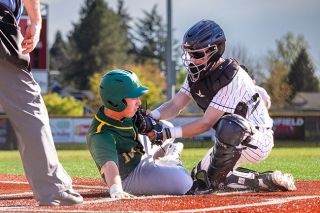 Nathan Ecker/News-register##Grizzlies&rsquo; senior catcher Drew Bizon tags out West Linn&rsquo;s Niko Hollabaugh while trying to score on a ground ball to third baseman Agustin Ponce-Lopez, who threw a dart to Bizon to cut down the run in their game on Thursday, April 9.