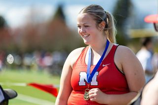 Rachel Thompson/News-Register##Brooklyn Johnston smiles wide with her gold medal from winning the hammer throw with a personal and school record of 121-00. Johnston set the previous Grizzly record at 118-4 during an Amity Thursday Throws event on July 17, 2025.
