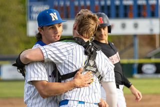 Nathan Ecker/News-Register##Newberg senior Judah Campos hugs his catcher Carter Hawes moments after the Tigers secured their first series win over McMinnville since 2012 with an 8-3 victory at Jim McDonnell Field on Friday, April 17.
