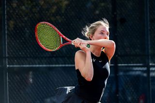 Nathan Ecker/News-Register## Caroline Rickards follows through on a two-handed return versus Newberg on Thursday, April 16. Intently, she watches the ball soar back to the Tigers in a match that showcased her extreme athleticism.