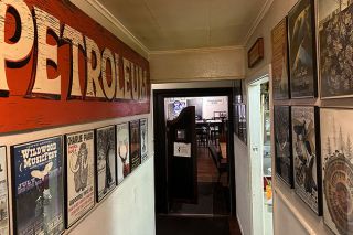 Kirby Neumann-Rea/News-Register##Poster pantheon lines Wildwood Hotel&rsquo;s back hallway walls.