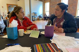Starla Pointer/News-Register##Home visitors Hortensia Gonzalez, left, and Yesenia Lopez talk about their work with families of Head Start students. They visit four times a year to teach information about parenting and also help families of children up to 5 years old find the resources they need. The women and other home visitors attended a celebration of Home Visiting Appreciation Week Tuesday at The Grand.