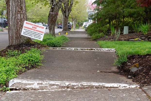 Rusty Rae/News-Register##A humorous sign describes what McMinnville Special Projects Manager Jody Christensen saw when she toured the Jandina neighborhood to take photos for Phase 1 of a Lower Income Neighborhood Accessibility project. &ldquo;No one can go on those sidewalks,&rdquo; Christensen told city councilors last week, &ldquo;Not a bike. Not a person.&rdquo;