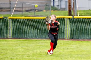 Nathan Ecker/News-Register##Freshman utility player Fiona Kreft rushes a shallow-looping fly ball from her post in centerfield versus Forest Grove. Kreft successfully nabbed all but one difficult fly ball in her first varsity start at the position.