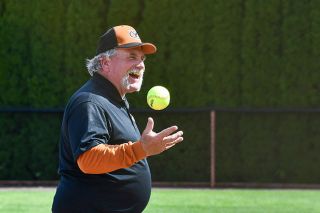 Photo courtesy of Cheryl Kuehnel##John Kuehnel flips a ball to himself while manning the third base coaches&rsquo; box at YC, a spot he&rsquo;s stood in for 29 years.