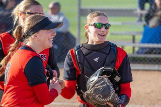 Nathan Ecker/News-Register##Mac seniors Alex Bates (left) and Ava Fleischman (right) share smiles after connecting to nab a Bowmen runner to end the top of the sixth inning. The Grizzlies&rsquo; defense was masterful, but the bats couldn&rsquo;t heat up versus Sherwood.