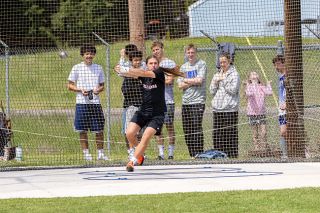 Nathan Ecker/News-Register## Willamina sophomore Billy DeLoe III gains centrifugal force before hurling his hammer through the air while a group of Amity on-lookers watch in awe of the event held on Saturday, May 2, during the Amity Invitational at AHS. DeLoe is a member of Amity&rsquo;s club track and field team and in the offseason competes alongside the likes of Jaxson Howard.