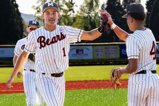 Nathan Ecker/News-Register##Freshman Bradley Woodward high fives Agustin Ponce-Lopez on his way back to the home dugout after successfully turning an inning-ending double play in the Grizzlies 6-1 win over Forest Grove on Wednesday, April 29.