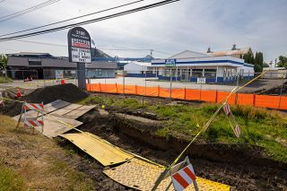 Rachel Thompson/News-Register##Workers are preparing to raze several small, old buildings to make room for a new, large U-Haul facility on Highway 99W in north McMinnville. The complex will include space for parking rental trucks, offices and indoor self-storage areas, as well.