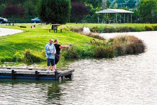 News-Register file photo##In this 2017 photo, a couple cast their lines at Vern Huddleston Memorial Pond in Willamina. Huddleston created the city&rsquo;s original fish pond on the old high school campus. When that was turned into a wastewater lagoon, the pond at Hampton Park was rededicated to honor Huddleston.