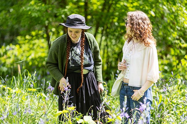 Rachel Thompson/News-Register##Freya and Hunter Kimbrough of Otis, walk among blooming camas near the Cozine Creek Friday during the Camas Festival on Friday, May 1, at Linfield University. Highlights of the festival included guided tours of the natural area, speakers, an Indigenous Creators&rsquo; Market, an art exhibit and children&rsquo;s activities.