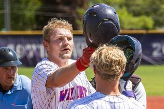 Nathan Ecker/News-Register##Wyatt Hurley taps helmets with Jackson Bui after crushing a home run in his final plate appearance as a Wildcat at Roy Helser Field on May 3 during the team&rsquo;s senior day.