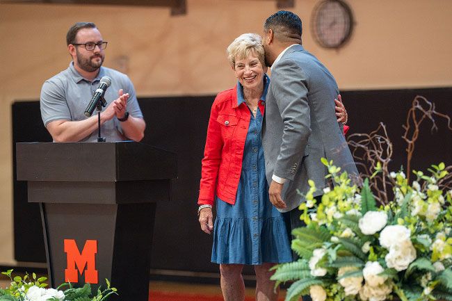 Rusty Rae/News-Register##Virginia &ldquo;Ginny&rdquo; Crabtree and Gabriel Del Rayo share an embrace on stage while honoring the Grizzlies&rsquo; departed soccer coach of &lsquo;06, Joe Crabtree. Ginny, Joe&rsquo;s wife, attended the ceremony and only asked that the former players in attendance stand and be recognized with individual rounds of applause.