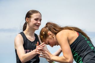 Nathan Ecker/News-Register##Katrina Huff (left) lends Lily Olivares (right) a helping hand after completing the girls&rsquo; 100-meter. The two West Valley natives are close off the track, taking lessons from each other into competition.