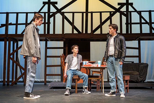 Rachel Thompson/News-Register##Johnny (Greyson Willis), left, and Dallas (Mitchell Ronning), right, confront each other in front of&nbsp; Ponyboy (AJ Elliott) in a scene from &ldquo;The Outsiders.&rdquo; Ponyboy and Johnny are on the run following violence in Tulsa, Oklahoma, where they are teens struggling to grow up. The three actors are part of a cast of 20 in the play at McMinnville High School.