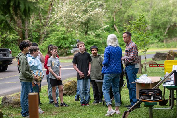 Rusty Rae/News-Register##Kim Libonati of the McMinnville Lions Club, second from right, and Eric Svec, dean of students at Duniway Middle School, give directions to sixth-graders who&rsquo;ve just arrived in Ed Grenfell Park Monday morning for a service day project. The students worked with Lions Club members to refurbish the park&rsquo;s horseshoe pits.